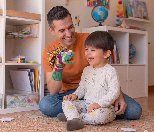 An early childhood assistant supporting a child at play