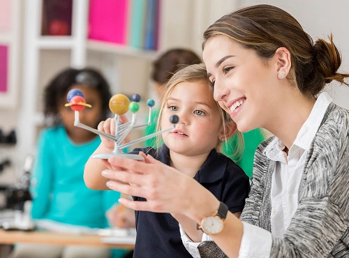 An early childhood educator reading with a young child